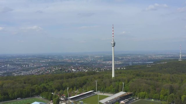 Aerial around the Frauenkopf forest in spring  in Stuttgart, Germany. Camera pans slowly right, with Stuttgart TV Tower Fernsehturm in center of shot.
