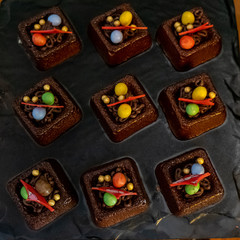 Chocolate mini cakes on display. Delicious Desserts in Buffet Line.