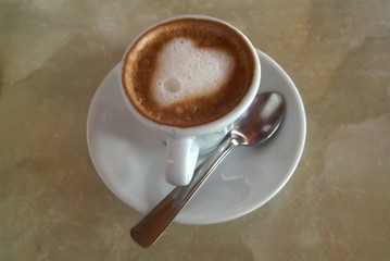 white coffee cup with heart shape made of foam