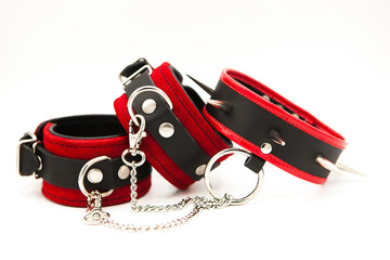 Leather handcuffs and collar with spikes isolated on white background. Sex toy for intimate...