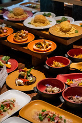 Catering banquet table with different food snacks and appetizers on corporate, christmas, birthday party event or wedding celebration