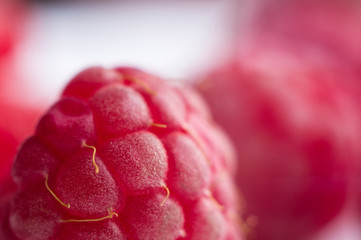 raspberries on a white saucer close up, macro photo