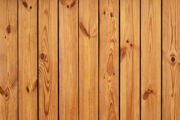 Fototapeta premium old wooden texture. a wall of vertical pine planks with a characteristic wooden pattern and knots