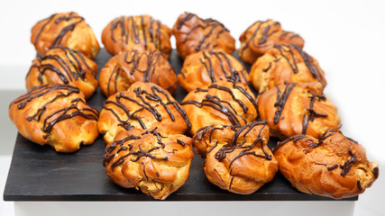 Delicious cakes eclairs on the table