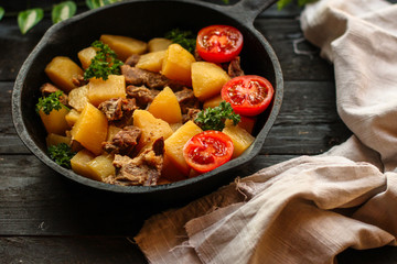 stewed potatoes with meat (goulash with vegetables). food background. top 