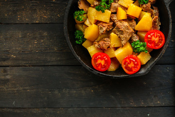 stewed potatoes with meat (goulash with vegetables). food background. top 