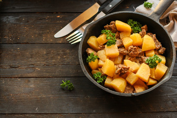 stewed potatoes with meat (goulash with vegetables). food background. top 