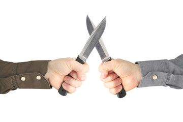 two hands with knives facing each other. Confrontation and war