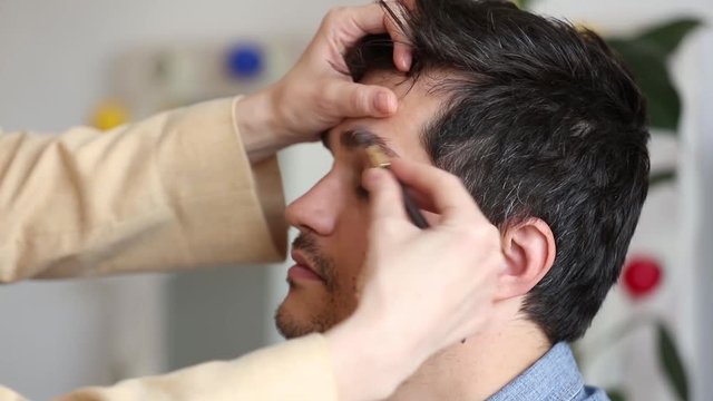 the young man plucked his eyebrows