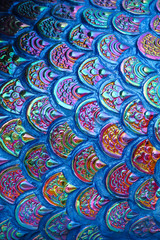 Close up a surface of naga or serpent scales stucco pattern at Thai Buddhist temple. 