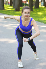 cute young athletic girl doing sports in nature