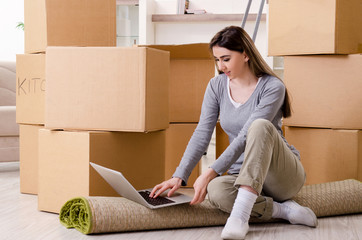 Young beautiful woman moving to new flat 