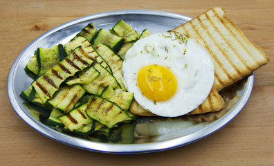 Fried egg with grilled zucchini and toasted bread