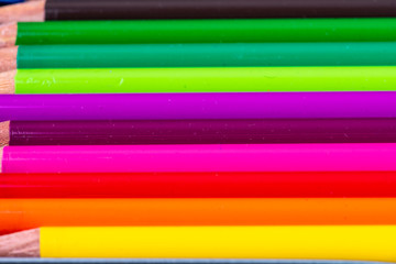 many colorful wooden pencils in very beautiful bright colors side by side
