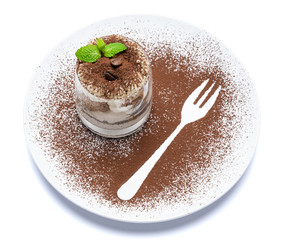 Classic tiramisu dessert in a glass on plate with fork silhouette isolated on a white with clipping path