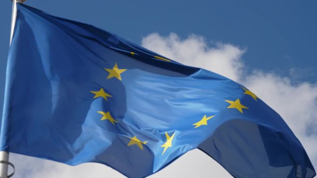 Big European Union flag fluttering proudly on a flagpole in Brussels in spring  