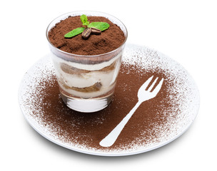 Classic tiramisu dessert in a glass on plate with fork silhouette isolated on a white with clipping path