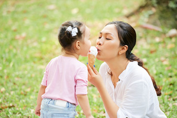 Mother and daughter eating ice cream