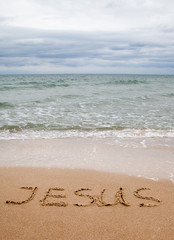 Word Jesus written on the sand