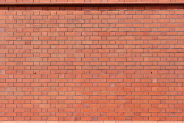 A photograph of a terracotta brick wall. Background texture, copy space, add your own text.  Red...