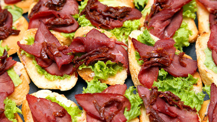 fresh sandwiches with ham and herbs on the table