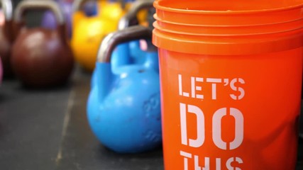 Kettle bell and orange bucket in Crossfit gym
