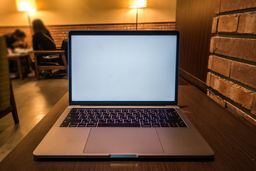 Conceptual workspace, Laptop computer with blank white screen on table, blurred background. use in Traditional Chinese Alphabet operating system.