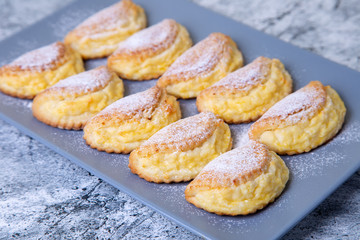 Sochniki (sochni) with cottage cheese. Traditional Russian shortbread with cottage cheese. Close-up, selective focus.