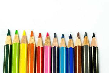 row of colored pencils on a white background