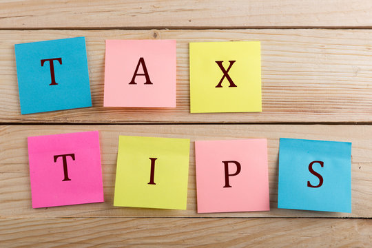 Business concept for taxpayer - Many colorful sticky note with text Tax tips
