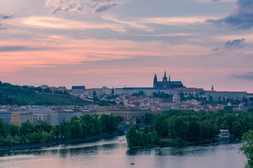 Colorful sunset sky above Old Prague castle and Vltava river