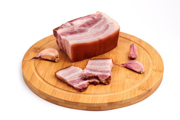Slices of fresh bacon on the wooden board on a white background. Isolated. Brisket.