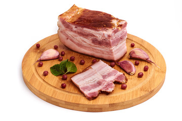 Slices of fresh bacon on the wooden board on a white background. Isolated. Brisket.