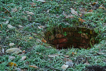 Concept of danger, safety cannot be half or partially. Not closed cover of a sewer manhole in park. 