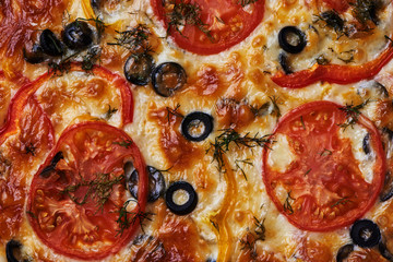 Delicious pizza with salami, olives, red pepper and tomato. Food texture background. 