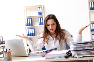 Young female employee unhappy with excessive work 