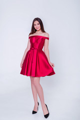 Fototapeta premium Beauty brunette model woman in cocktail dress. Beautiful fashion luxury makeup and hairstyle. Seductive girl silhouette on white background.