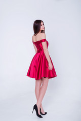 Beauty brunette model woman in cocktail dress. Beautiful fashion luxury makeup and hairstyle. Seductive girl silhouette on white background.