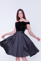 Fototapeta premium Beauty brunette model woman in cocktail dress. Beautiful fashion luxury makeup and hairstyle. Seductive girl silhouette on white background.