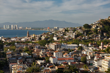 Puerto Vallarta at sunset with Sierra Madre mountains Our Lady of Guadalupe and Holy Cross churches