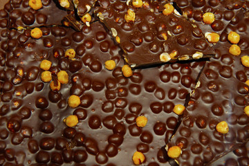 black chocolate bricks with nuts for background