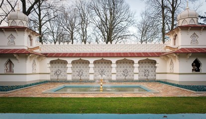 Traditional Persian design of the persian palace with painted walls, tiles and wooden doors, attraction in themepark with fakir on a flying carpet