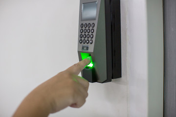 Finger scan on machine Security concept and safety. soft focus on hand scanning finger on machine concept. Businessman hand scanning finger on machine,Technology concept or Business concept.
