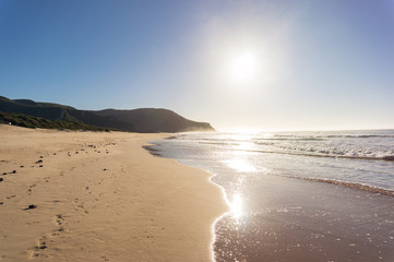 Beach landscape with soft waves and bright sunshine