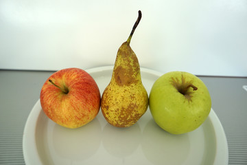 Fruit served on the tray and photographed on white plate