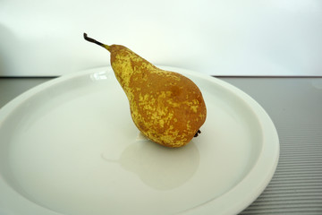 Fruit served on the tray and photographed on white plate