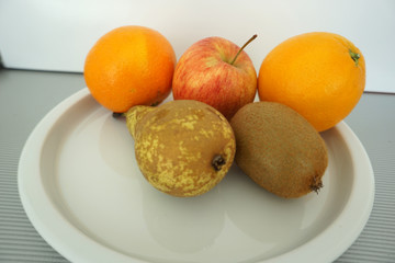 Fruit served on the tray and photographed on white plate
