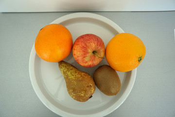 Naklejka na ściany i meble Fruit served on the tray and photographed on white plate