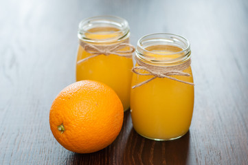 Orange juice in jars and whole fruit rustic style
