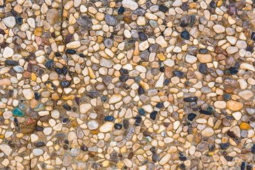 Close-up of stone wall with different pebbles.